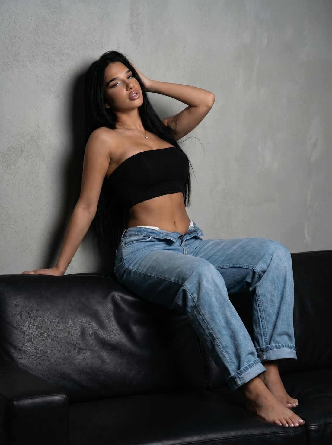 A generated frame of a model on a sofa between takes