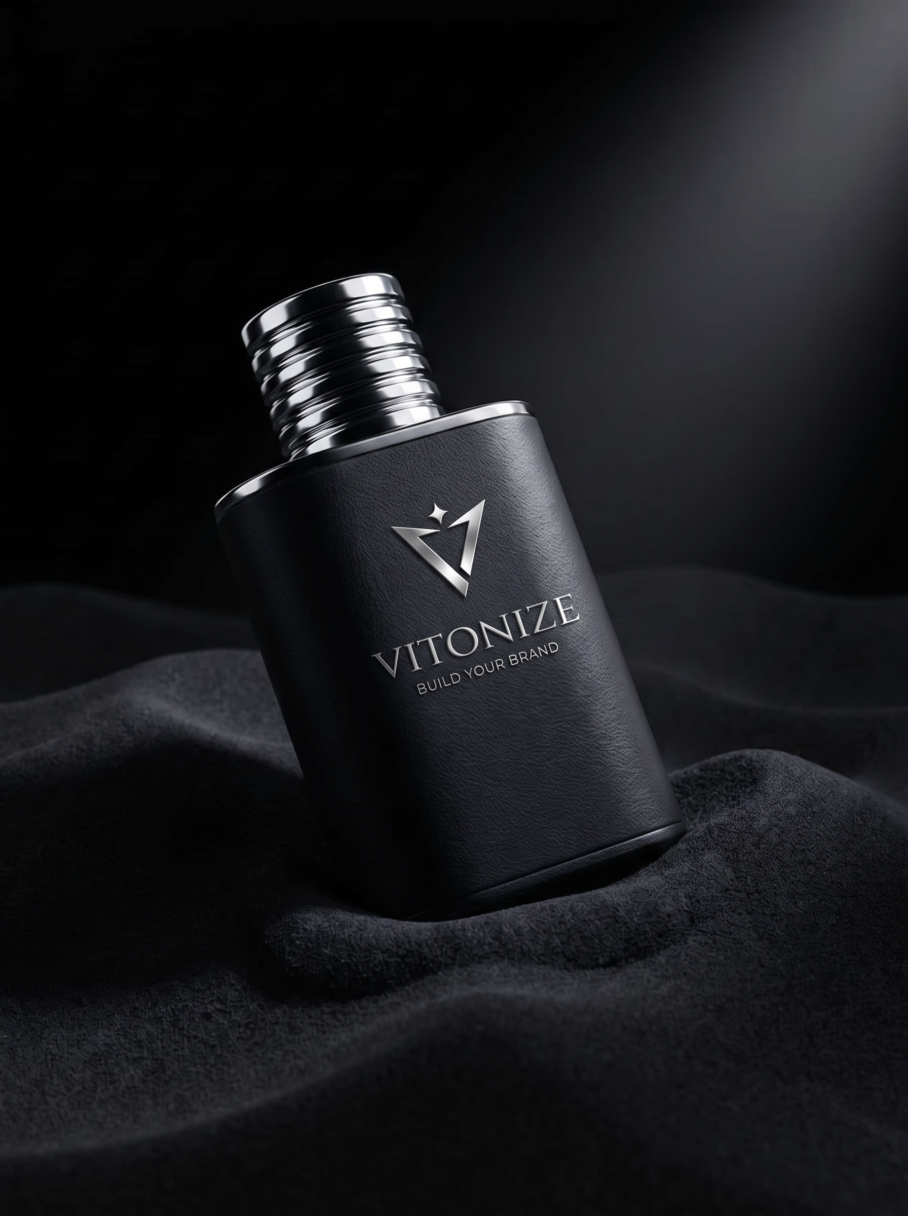 Fragrance bottle ad with water spray on dark stone